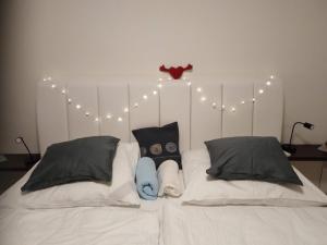 a white bed with lights and pillows on it at Academic Apartment Brno (AAB) 2+1 (62 m²) in Brno