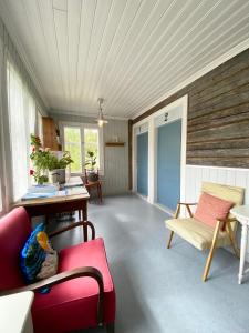 a living room with a red couch and a table at Wästinn in Vöyri