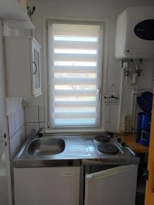 a small kitchen with a sink and a window at Doppelbungalow Ostsee Nr. 8 + 9 in Ahlbeck