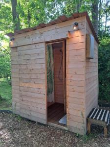 a wooden out house with a shower in it at De Koekoek in Bruges