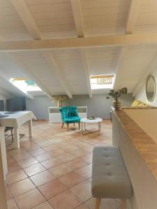 a living room with a blue chair and a table at Apartments Papilon in Vrsar +13 photos