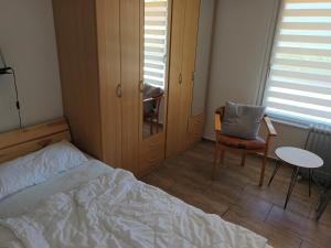 a bedroom with a bed and a chair and a table at Doppelbungalow Ostsee Nr. 8 + 9 in Ahlbeck