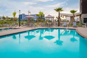a swimming pool at a hotel with blue water at TownePlace Suites by Marriott San Bernardino Loma Linda in Loma Linda