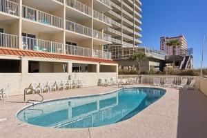 a swimming pool in front of a apartment building at Clearwater 1D in Gulf Shores