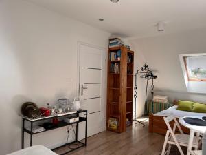 a bedroom with a bed and a book shelf at Garden Room in Mikoszewo