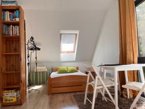 a bedroom with a bed and a table and chairs at Garden Room in Nickelswalde