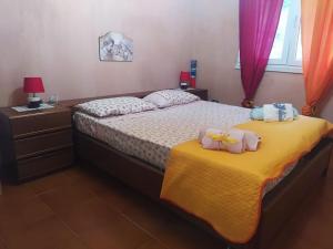 a bedroom with two beds with towels on them at House Mare & Supramonte in Baunei