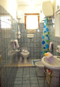 a bathroom with a toilet and a sink at House Mare & Supramonte in Baunei