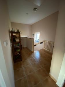 an empty living room with a tiled floor and a table at Domeček s výhledem in Martínkovice