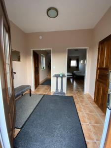 a living room with a table and a hallway at Domeček s výhledem in Martínkovice