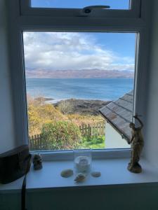 a window with a view of the ocean at Tighnamara-Skye in Saasaig