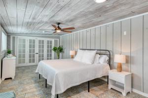 a bedroom with a bed and a ceiling fan at Sunset Dreams in Saint Augustine