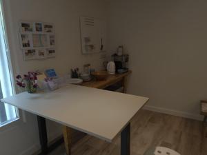 a kitchen with a white table in a room at 't KlupHoes in Maastricht