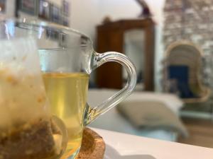 a glass mug of tea sitting on a table at 't KlupHoes in Maastricht