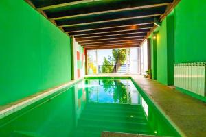 an indoor swimming pool with green walls and a green wall at La Casa del Lago Nahuel in San Carlos de Bariloche