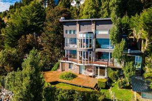 an aerial view of a house on a hill at La Casa del Lago Nahuel in San Carlos de Bariloche