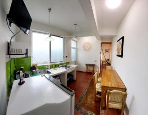 a kitchen and dining room with a table and a refrigerator at Casa Puerto Bonito & Private Coworking in Puerto Escondido