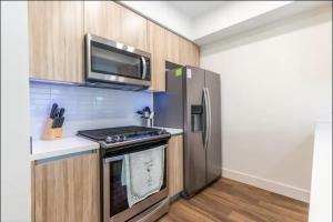 a kitchen with a stainless steel refrigerator and a microwave at Luxury 2bedroom 2bath Santa Monica in Los Angeles