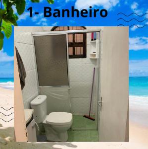 a bathroom with a toilet on the beach at Casa de praia completa in Mongaguá