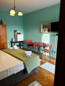 a room with a bed and a table and chairs at Private Terrace Room - Free Parking - Near Airport & Center in Kaštela