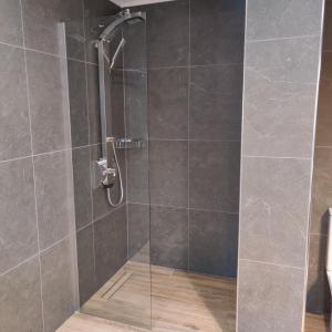 a shower with a glass door in a bathroom at Mare Monte Luxury Apartments 4 in Kassandria