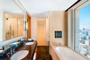 a bathroom with two sinks and a large window at St. Regis Osaka in Osaka