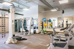 a gym with several treadmills and machines in a room at Hotel Adeline, Scottsdale, a Tribute Portfolio Hotel in Scottsdale