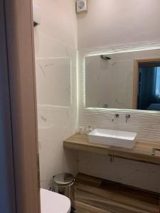 a bathroom with a sink and a mirror at Alani house in Tinos +6 photos