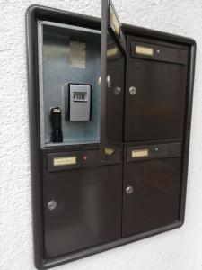 a black cabinet with a microwave in a wall at Seepanoramablick in Gmunden