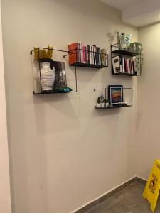 a room with two shelves on the wall with books at Turunç Hotel ANTALYA in Antalya