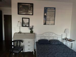 a bedroom with a bed and a dresser at Apartament Awiator Gdańsk in Gdańsk