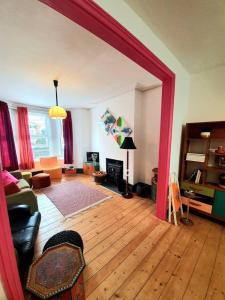 a living room with a large red doorway into a living room at Casa Colour Margate in Margate