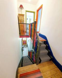 a spiral staircase in a home with colorful carpet at Casa Colour Margate in Margate