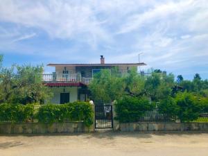 a large house with a fence in front of it at O&A By the Sea in Polykhrono