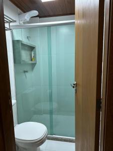 a bathroom with a toilet and a glass shower at Villa Andorinha, Apt 03 in Mucugê +19 photos