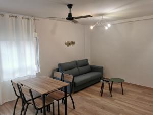 a living room with a couch and a table at Apartamentos Cuéntame Burgos - VUT in Burgos