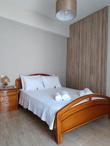 a bedroom with a large bed with white pillows at Panos House - Warm and cozy retreat in Tríkala