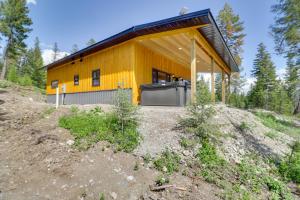 a yellow house on top of a hill at Lakeside Vacation Rental with Private Hot Tub in Lakeside