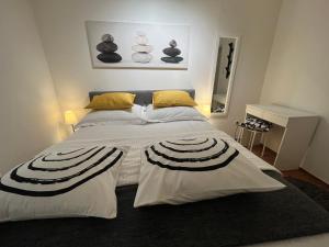 a bedroom with a large white bed with yellow pillows at Apartman Passagio in Rovinj