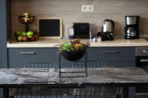 a table with a bowl on top of it in a kitchen at Porto Boutique #B in Thessaloniki +3 photos
