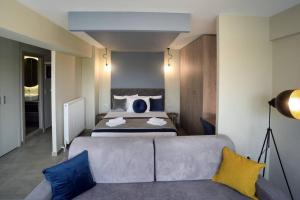 a bedroom with a bed and a couch in a room at Porto Boutique #B in Thessaloniki
