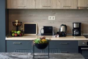 a kitchen with a counter with fruits and a microwave at Porto Boutique #B in Thessaloniki