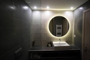 a bathroom with a sink and a mirror at Porto Boutique #B in Thessaloniki