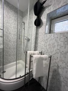 a bathroom with a shower and a bath tub with towels at Apartman Passagio in Rovinj +13 photos