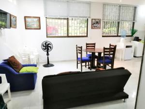 a living room with a couch and a table and chairs at Casa en Condominio Santa Helena in Yaguará