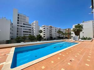 a swimming pool on the roof of a building at Luxury Modern Beach Apartment in Quarteira