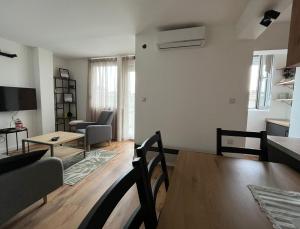 a living room with a table and a couch at Sailboat Apartment in Niš