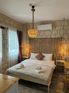 a bedroom with a bed with towels on it at Hera Hotels Alaçatı in Cesme