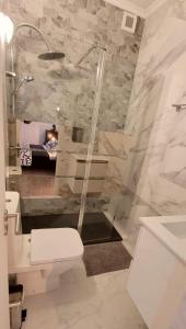 a bathroom with a shower and a toilet and a sink at Village Cascais Guest House in Cascais