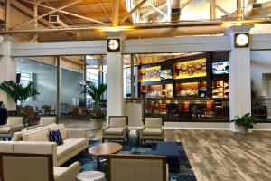 a lobby of a hotel with couches and a bar at Southbank Hotel by Marriott Jacksonville Riverwalk in Jacksonville